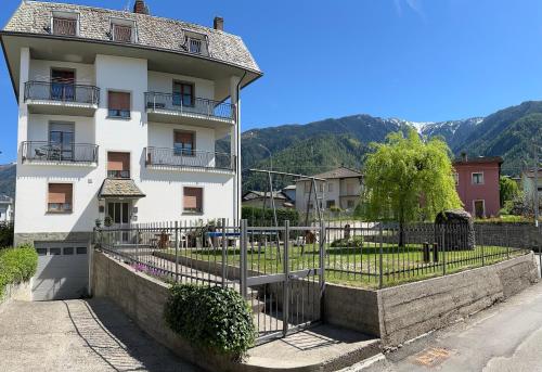 a white building with a fence in front of it at CASA STAVELLO in Sernio