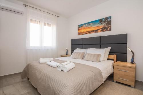 een slaapkamer met een groot bed en handdoeken bij Ferienwohnung für 4 Personen ca 75 qm in Vir, Dalmatien Inseln vor Zadar - b53410 in Vir
