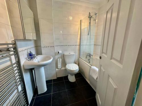 a bathroom with a sink and a toilet and a shower at Pass the Keys A BeachhouseHome away from Home in Clacton-on-Sea