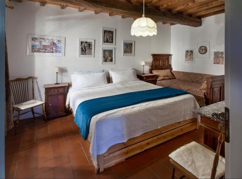 グレーヴェ・イン・キアンティにあるVilla Buonasera Agriturismoの大きなベッドと椅子のある寝室