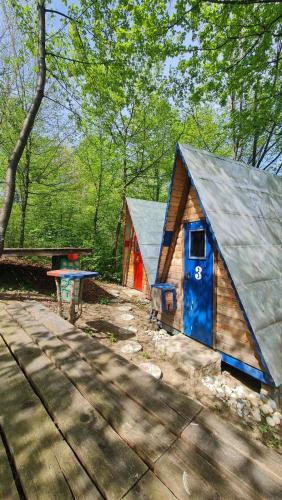 a small cabin in the woods with a picnic table at Cabin 3 Hill Station in Sarajevo