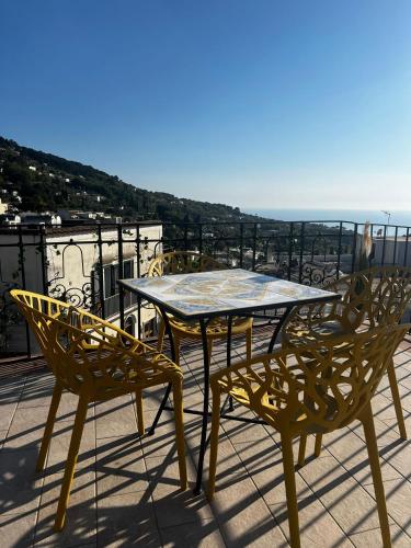 a table and two chairs on a balcony with a view at Casa La Radio in Anacapri