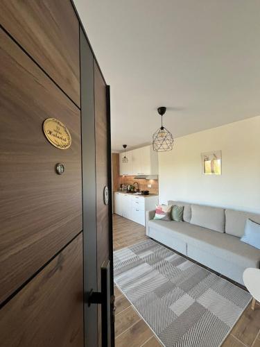 a door leading to a living room with a couch at Apartmani Živković in Veliko Gradište