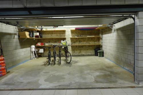 a garage with two bikes parked in it at Superbe loft de caractère avec garage à 10' du centre in Liège