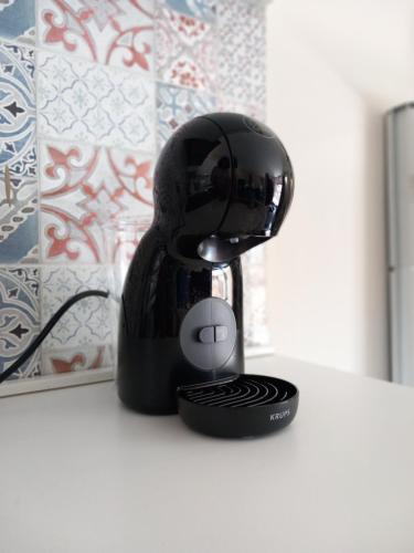 a black coffee maker sitting on a counter at Bluesky Apartment Naxos 3rd floor in Giardini Naxos