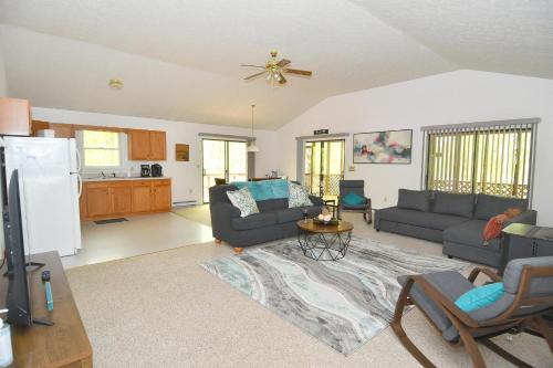 a living room with two couches and a kitchen at Namba Cabin -- Pet Friendly, River Access, Grill, Wifi, Deck, Screen Porch, Family Friendly in Morton Grove
