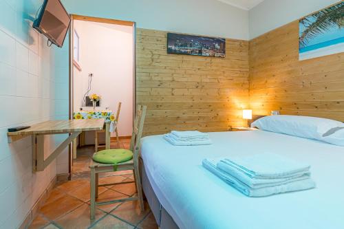 a bedroom with a bed and a desk and a table at Residence Paolino in Tavernerio