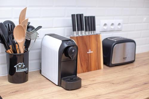 a toaster sitting on a counter next to a knife block at Transylvania Forest Haven-Luxury Cabin in Filia