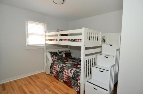 a bedroom with a bunk bed and a white bunk ladder at Bear Necessities -Forget your Worries! in Great Cacapon