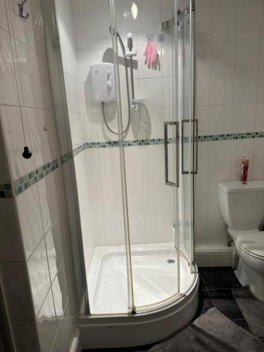 a shower with a glass door in a bathroom at 10 Edney Court in Earley