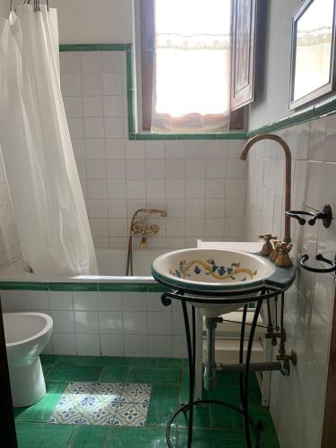 a bathroom with a sink and a bath tub at Guest House Torre Guelfa, Vinsantaia in Figline Valdarno
