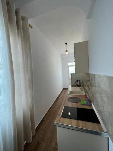a kitchen with a counter with a sink and a mirror at Perdja Apartment III in Velipojë