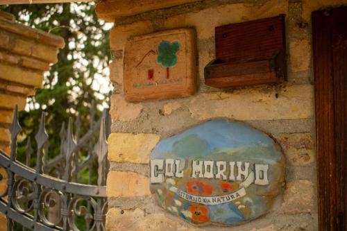 a stone wall with a sign on it at Agriturismo Col Morino in Pineto