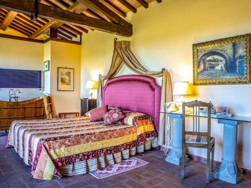 a bedroom with a large bed with a pink headboard at Casale di Buccole in Migliano