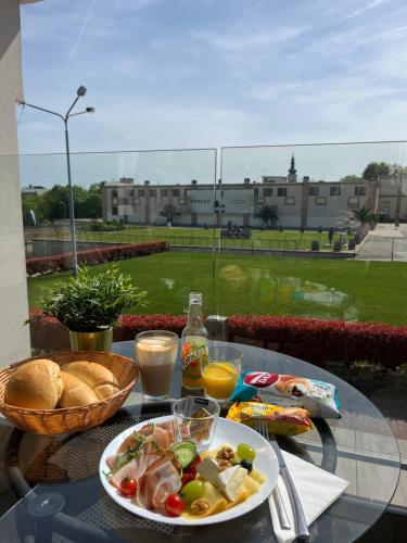 a table with a plate of food on a balcony at Boutique Hotel & Event Center in Budapest