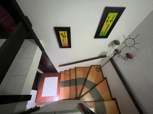 a room with a staircase with paintings on the wall at VILLA LEWANA 2 in Villa de Leyva