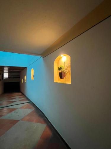 a hallway with a window with a potted plant in it at VILLA LEWANA 2 in Villa de Leyva