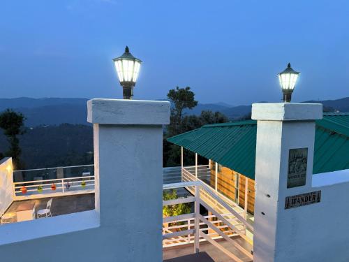 two lights on top of a building with a roof at Wanderlust Mukteshwar in Mukteswar