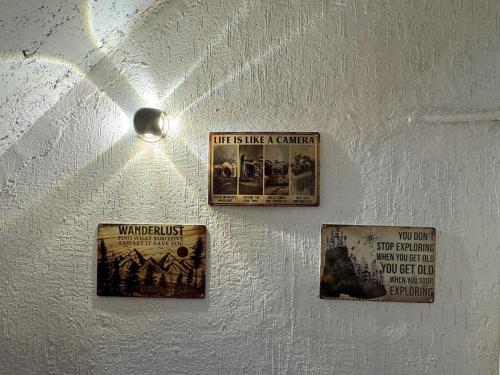 three posters on the wall of a room at Wanderlust Mukteshwar in Mukteswar