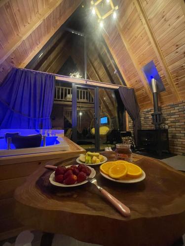 a table with fruit on it in a room at Modul Suit & Bungalov in Rize