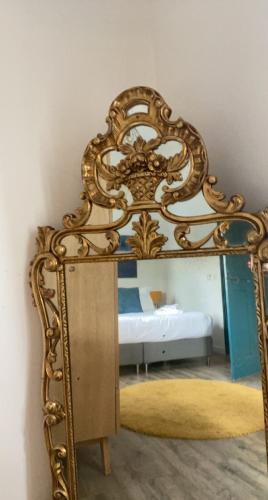 an ornate mirror in a room with a bed at Villavos- Le Bocage in Cassis