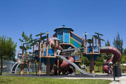 a playground in a park with a water slide at Covelo Apartment in Porto