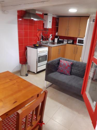 a living room with a couch and a kitchen at Casa da Avó - Barroca in Barroca