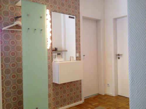 a bathroom with a sink and a mirror on a wall at HertenFlats - Rooms & Apartments - Kreis Recklinghausen in Herten