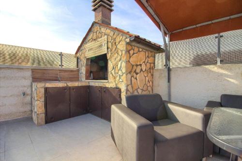 a patio with a building with a door and chairs at Ferienhaus mit Privatpool für 5 Personen ca 80 qm in Loborika, Istrien Südküste von Istrien in Loborika