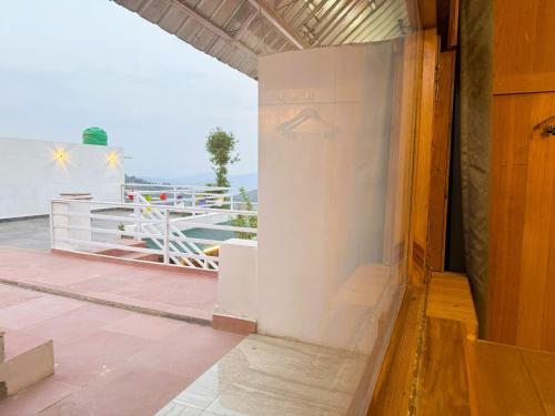 a view from the balcony of a house at Wanderlust Mukteshwar in Mukteswar