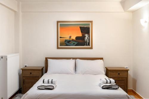 a bedroom with a bed with a picture on the wall at Del Mountain Home Arachova in Arachova