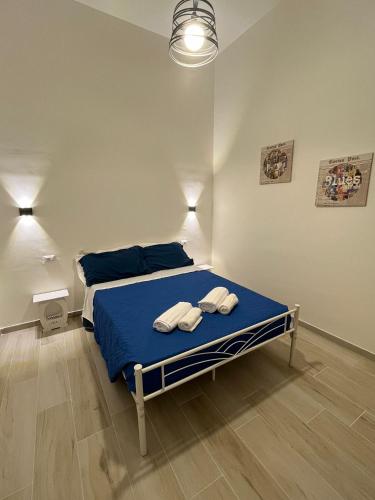 a bedroom with a bed with two towels on it at Casa vacanza Sofiu' in Mazara del Vallo