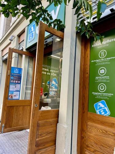 a door to a store with a sign on it at Elegant Apt 50meters Close Acropolis in Athens
