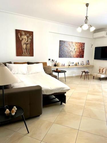 a bedroom with a bed and a living room at Elegant Apt 50meters Close Acropolis in Athens