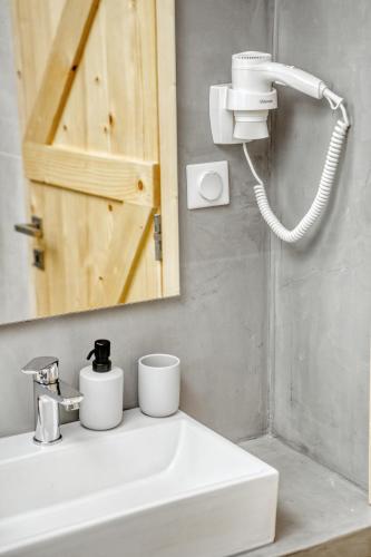 a bathroom with a sink and a mirror at Kumquart estate- Grape fruit in Aspiotádes
