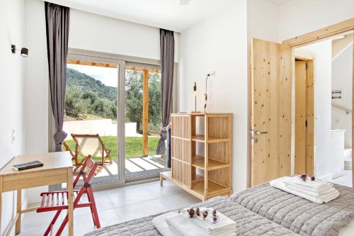 a bedroom with a bed and a desk and a window at Kumquart estate- Grape fruit in Aspiotádes