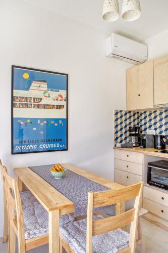a kitchen with a wooden dining table and chairs at Kumquart estate- Grape fruit in Aspiotádes