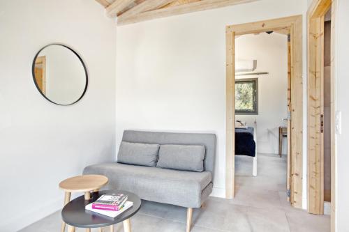 a living room with a couch and a table at Kumquart estate- Grape fruit in Aspiotádes