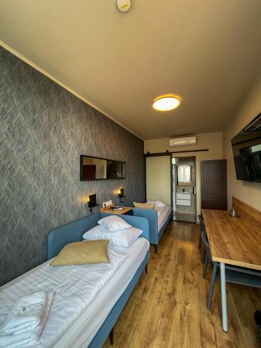 a hotel room with two beds and a table at Boutique Hotel & Event Center in Budapest
