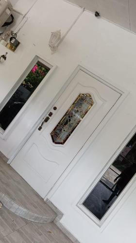 a room with three windows and a white wall at Sutera Homestay in Sungai Petani