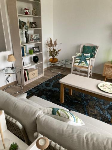 a living room with a couch and a table at Maison proche de la Loire in Saint-Georges-de-Baroille