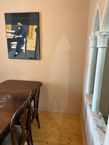 a dining room with a table and a picture on the wall at City center apartment in Constanţa