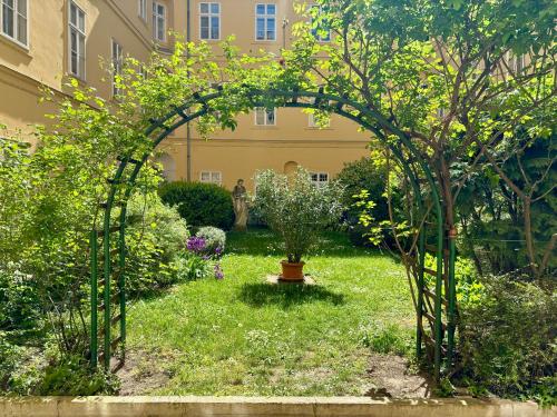 an archway in a garden with a plant at Chic & Zen in Budapest