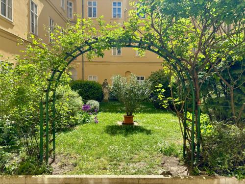 an archway in a garden with a plant at Chez Marie in Budapest