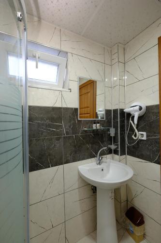 a bathroom with a sink and a shower at Venüs Hotel in Antalya