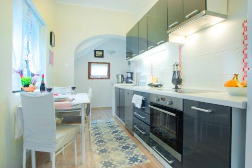 a kitchen with a counter and a table in it at Ferienwohnung für 2 Personen ca 32 qm in Milčetići, Kvarner Bucht Krk - b58170 in Malinska