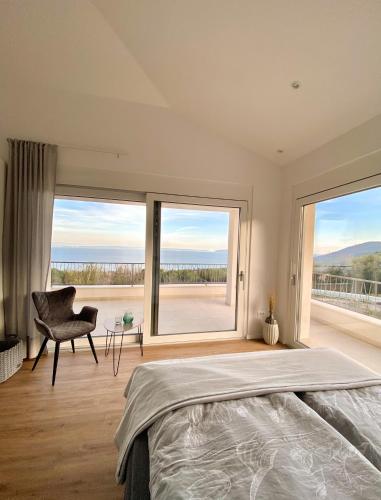 a bedroom with a bed and a large window at Villa Maritima Opatija-Meerblick-Infinity Pool-Luxus-Relax in Opatija