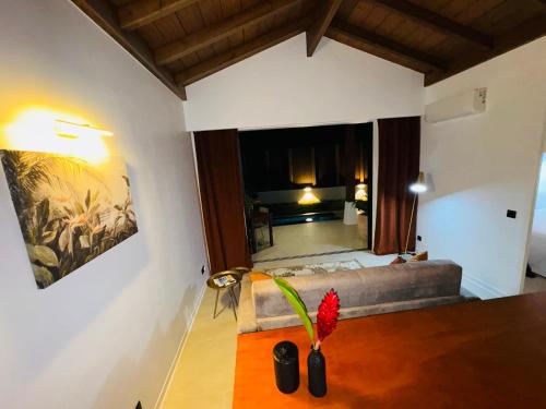 a living room with a couch and a large window at Tropical Lodges … Le Gosier in Le Gosier