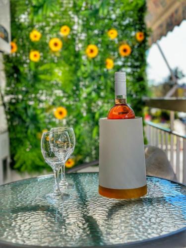 a bottle of wine and a wine glass on a table at Psimithefto Luxury Apartments in Thessaloniki