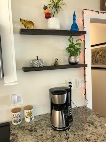 a coffee maker on a counter in a kitchen at River Run Cottage Modern 2BR Waterfront Retreat in Linville Land Harbor in Newland